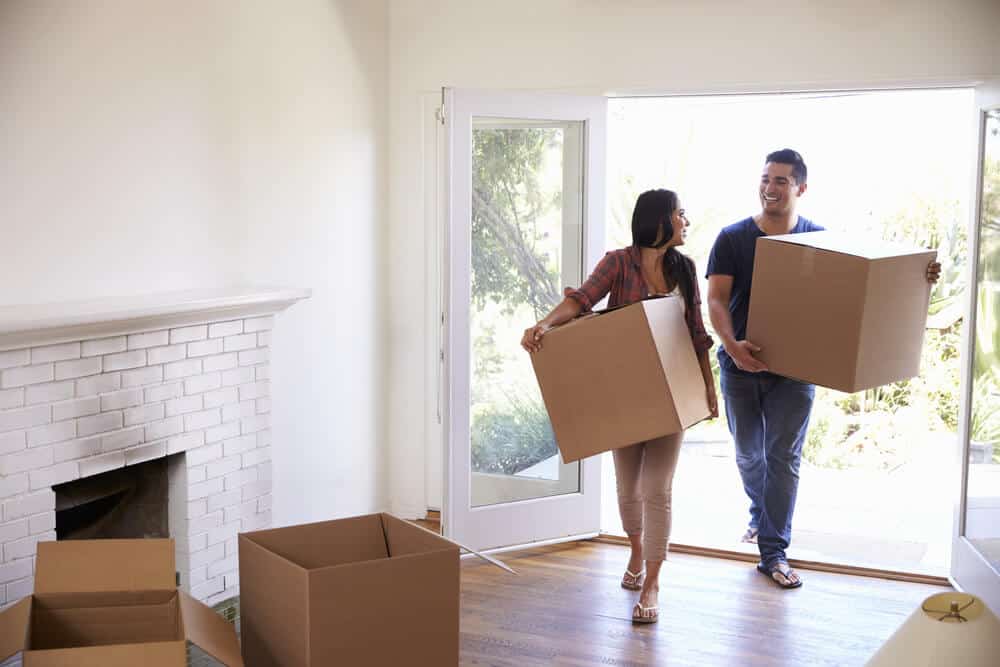 Happy Couple Moving Into Newly Purchased Home